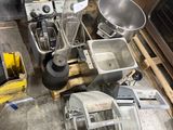 a pile of kitchen appliances and appliances on a pallet in a warehouse