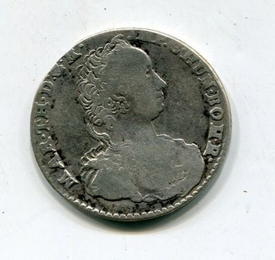 une vieille pièce d'argent sur laquelle figure le profil d'une femme