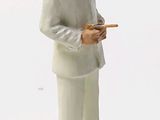 a figurine of a man in a white suit holding a pencil