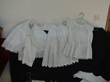 a pile of clothes that is sitting on a black suitcase