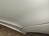a close up of a car ' s front bumper and fender