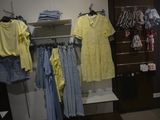 a lot of clothes hanging on a rack in a room