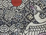 a close up of a piece of fabric with a bird on it