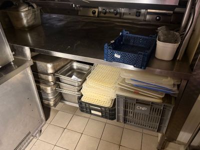 a kitchen with stainless steel counter tops and pots and pans on the counter