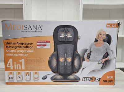 the box is open on the table with a woman sitting in a chair