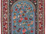 a blue rug with a red border and floral design