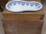 a blue and white bowl sitting on a wooden box
