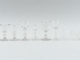 a lot of wine glasses sitting on a table