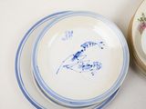 a stack of plates with blue and white designs on them