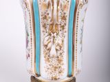 a vase that has a bird on top of it
