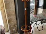 a coat rack and a table in the corner of a room