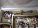 a lot of silverware in a box with a spoon and a bowl