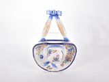a small blue and white clock with a bow on it