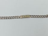 a close up of a silver chain bracelet on a white surface
