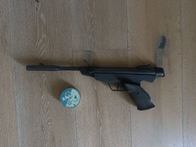 a gun and a ball on the floor next to it