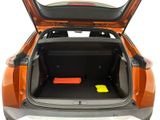 an open trunk of an orange car with its doors open