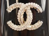 a gold ring with a chanel logo on it