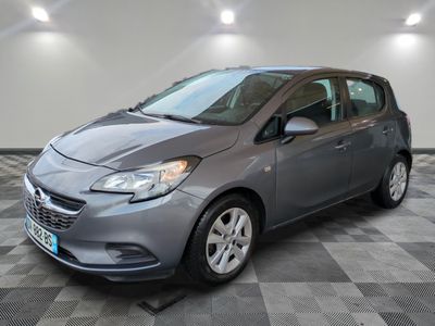 a gray car is parked in a room with a checkered floor