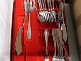 a red box with silverware in it on a table