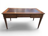 a wooden desk with a glass top on a white background