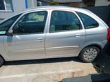 a silver car that is parked on the side of the street