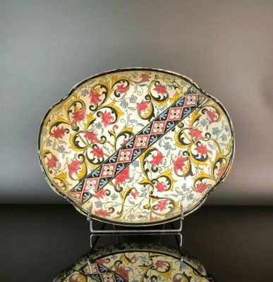 a decorative plate on a stand on a table