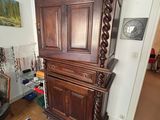 a large wooden cabinet in the corner of a living room