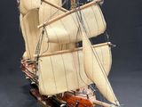 a small model of a sail boat on a table