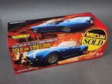 the box is open to show the model of a blue sports car