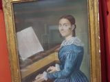 painting of a woman in a blue dress sitting at a piano