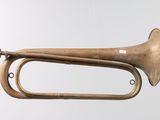 an old brass trumpet hanging from the ceiling