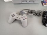 a video game controller sitting next to a box of games