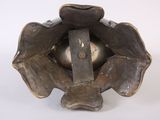 a metal object that is sitting on a white surface