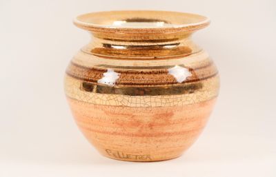 a vase that is sitting on a white surface
