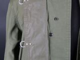the jacket is green and has two buttons on the collar