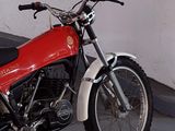 a red and white motorcycle parked in a parking lot
