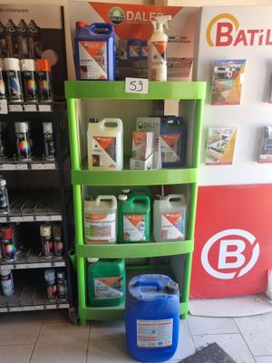 a shelf of cleaning products in a store next to a refrigerator