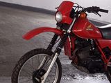 a red motorcycle that is parked in a garage