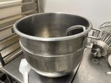 a large metal bowl sitting on top of a metal table