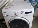 white washing machine sitting on tiled floor next to blue hoses