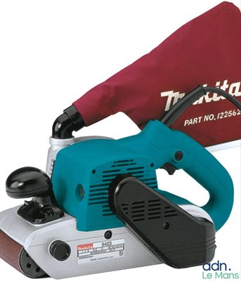 the corded sander is being used to sand a piece of wood