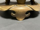 a bronze vase that is sitting on a table