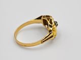 a gold ring with a skull head and a diamond in the middle