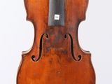 an old violin with a bow hanging from it ' s back