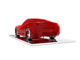 a model of a red car on display on a white surface