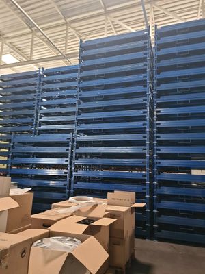 pallets in a warehouse with boxes stacked on top of them