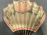 a fan that has been decorated with flowers on it