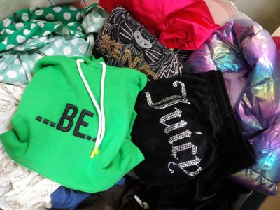 a pile of clothing that is sitting on a bed