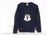 a sweatshirt with a mickey mouse face on it next to a card