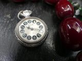 a close up of a pocket watch on a table